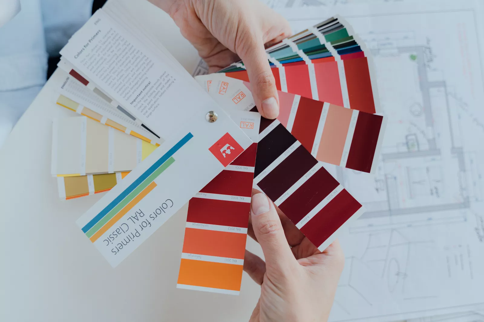 Hands holding color palettes