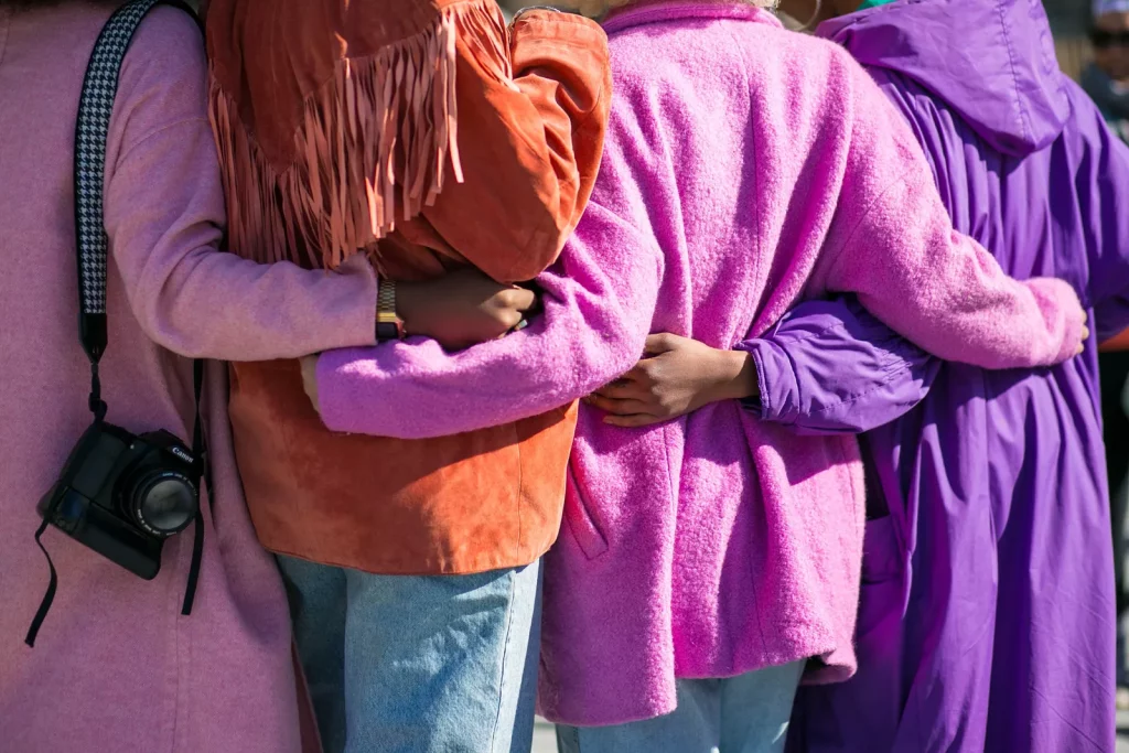 Group of people with their arms wrapped around each other