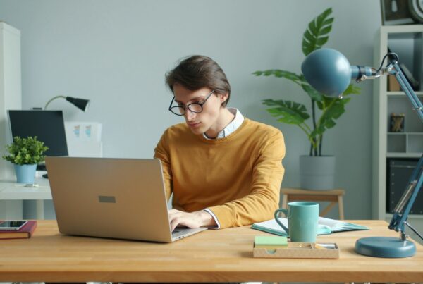 A designer analyzing user experience (UX) data on a laptop, improving website usability and customer satisfaction for better business performance.