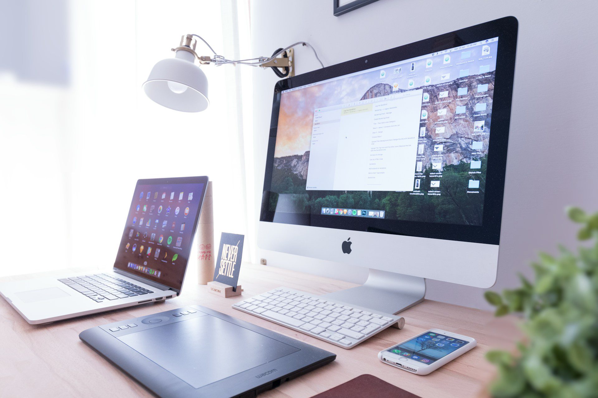 A computer monitor and a laptop on a table
