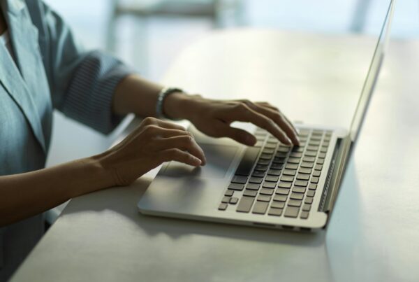 A person typing on a laptop