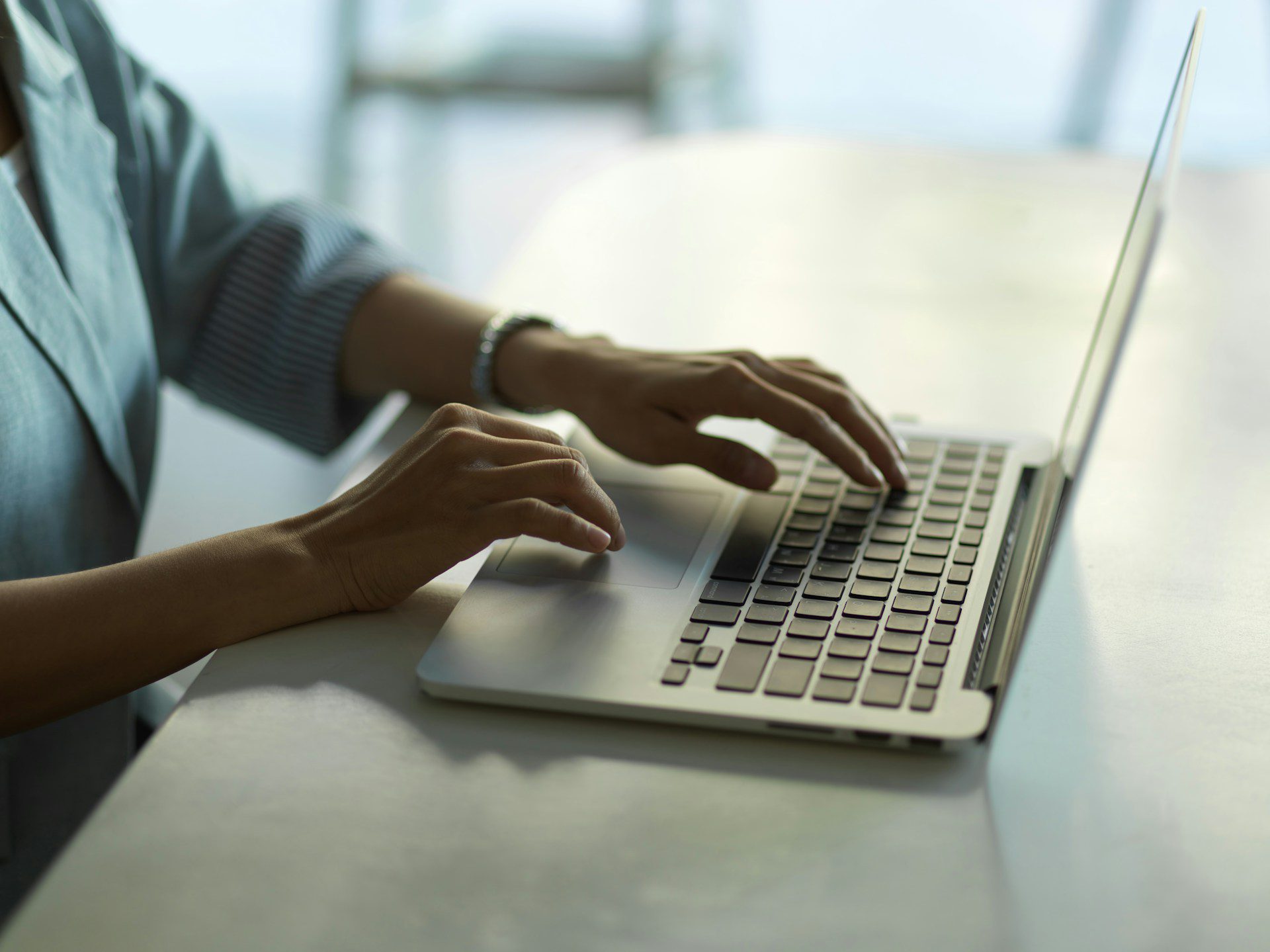 A person typing on a laptop