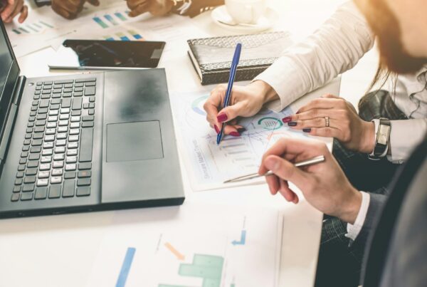 Two person holding a pen