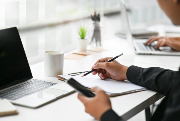 A person writing on a paper